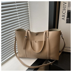 Detail of beige PU leather tote bag with dual handles and detachable shoulder strap