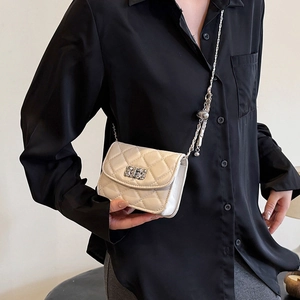 Chic quilted cream crossbody bag with silver chain strap and metal ball detail