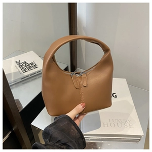 Detail shot of the brown crescent Hobo bag featuring premium PU texture and zipper closure
