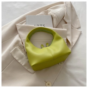 Detail of lime green half-moon hobo bag with silver double zipper and smooth PU leather