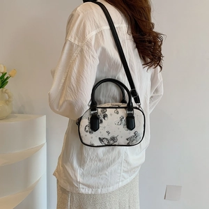 Retro butterfly print Boston handbag with black handles and adjustable shoulder strap