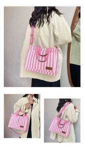 Detailed view of pink striped canvas tote bag with detachable strap and leather patch