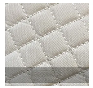 Macro shot of high-quality quilted fabric with classic diamond pattern for handbags