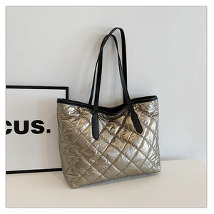 Détail du sac cabas matelassé champagne doré avec anses noires et texture métallique