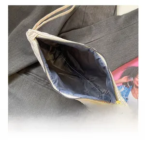 Macro shot of the spacious dark blue inner lining and golden zipper of this quilted clutch