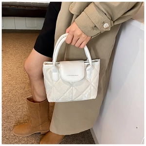 Close-up of white quilted tote bag with FASHION & BAGS text and metallic finish