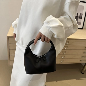 Minimalist black matte leather hobo handbag with half-moon design and silver zipper detail