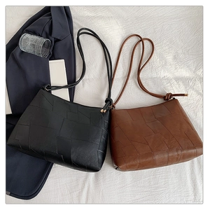 Chic underarm bags in black and brown leather with minimalist geometric patchwork design