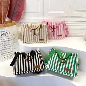 Vertical striped canvas tote bag in four colors with brown leather fashion label