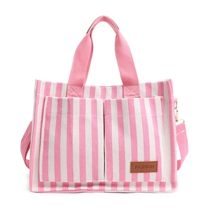 Pink striped canvas tote bag with front pockets and adjustable crossbody strap