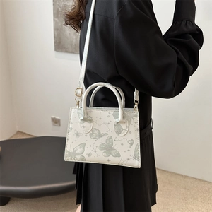 Sac bandoulière blanc avec imprimé papillon vert et bandoulière réglable pour femme