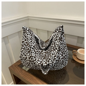 Large leopard print canvas tote bag on a wooden table for casual daily fashion