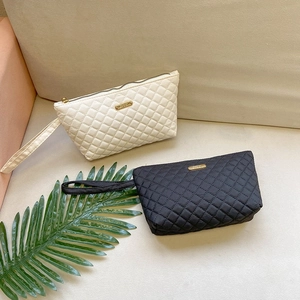 Elegant quilted rhombus patterns on high-capacity envelope clutch bags in black and white