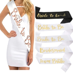 Close-up of bridal party sashes with gold Bride to be and Bridesmaid lettering
