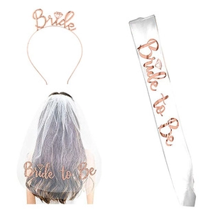 Close-up of bride to be set with rose gold headband, white veil and satin sash accessories
