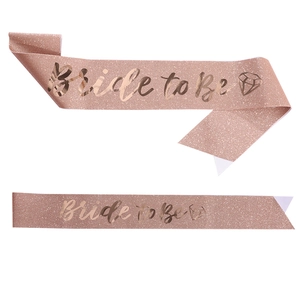 Detail of rose gold glitter sash with gold foil Bride to Be text and diamond icon