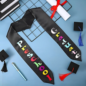 Detail of black satin preschool graduate stole with rainbow text on graduation background