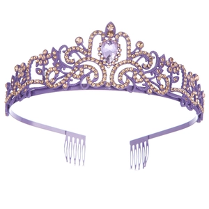 Detail of purple alloy crown with champagne crystals and teardrop gem on white background