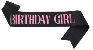 Detail of black glitter fabric birthday sash with rose gold BIRTHDAY GIRL lettering