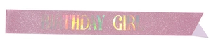Close-up of pink glitter sash with iridescent Birthday Girl holographic lettering