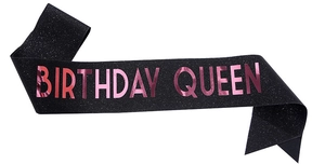 Close-up of black glitter birthday queen sash with rose gold metallic lettering