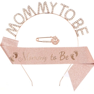 Close-up of rose gold Mommy to Be tiara and pink glitter sash with pin set