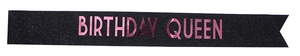 Detail of black glitter birthday queen sash with shiny pink metallic lettering
