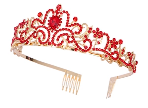 Detail of red crystal crown with gold branches, pear-shaped center stone and hair combs