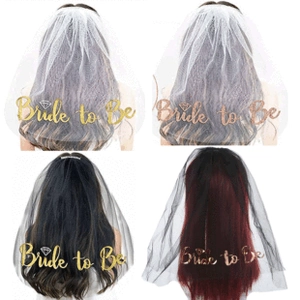 Detail of white and black Bride to Be sashes and veils with gold lettering