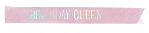 Detailed shot of pink glitter Birthday Queen sash with holographic lettering on white backdrop