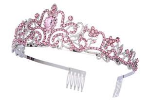 Detail of silver alloy crown with pink crystals and intricate floral hollow design