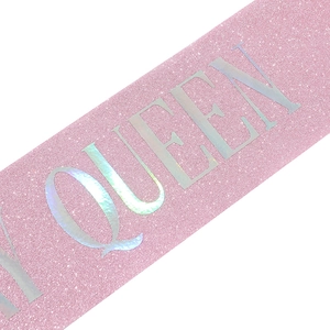 Close-up of pink glitter sash with holographic silver Queen lettering for birthday parties