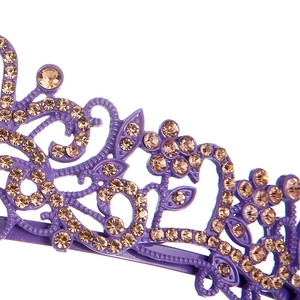 Close-up of purple alloy crown featuring champagne rhinestones and scrollwork detail