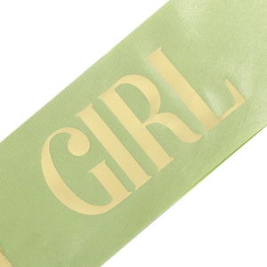Detail of mint green satin sash with metallic gold 'GIRL' lettering for birthday party