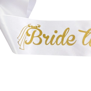 White satin Bride to Be sash with gold glitter lettering and crown for bridal parties