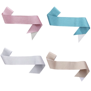 Detail view of four glitter party sashes in pink, light blue, silver, and champagne gold colors