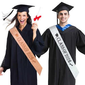 Detail of rose gold and silver Class of 2026 graduation sashes with glitter texture