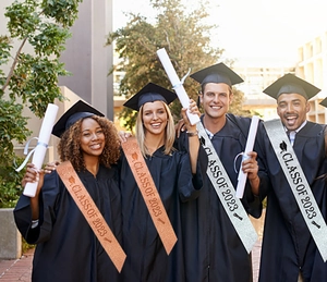 Close-up of rose gold and silver glitter Class of 2023 graduation sashes on students