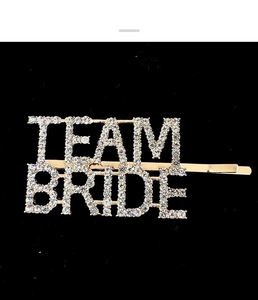 Detailed view of Team Bride hair pin with gold finish and sparkling crystal rhinestones