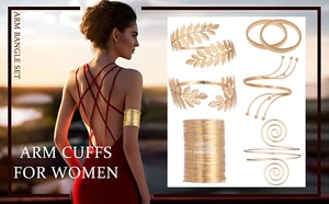 Detailed view of leaf-textured and spiral gold arm cuffs set on female model