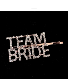 Macro detail of Team Bride rose gold hair clip with shimmering inlaid rhinestones