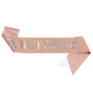 Close-up of rose gold glitter sash with colorful holographic Birthday Princess text