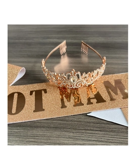 Close-up of rose gold tiara with sparkling rhinestones and matching glitter sash