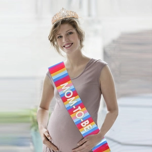 Detail of Mom To Be party sash with colorful stripes and sparkling crystal tiara crown