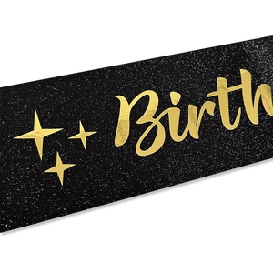 Detail of black glitter sash with gold metallic Birthday star lettering for parties