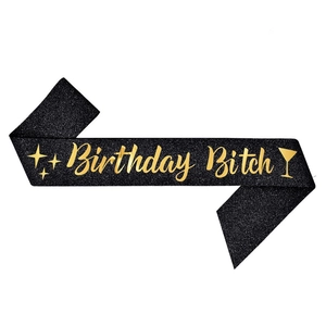 Detail of black glitter birthday sash with gold Birthday Bitch text and cocktail icons