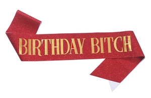 Detailed view of red glitter party sash with gold foil BIRTHDAY BITCH lettering