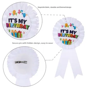 Detailed view of white pleated ribbon birthday badge with pin-back and festive prints