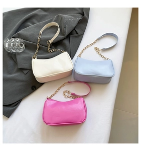 Three minimalist half-moon shoulder bags in beige, light blue, and pink with chain straps