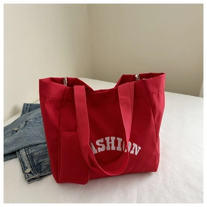 Macro shot of red Oxford tote bag featuring fashion print and functional front pocket